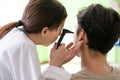 The female doctor checking patient`s ear during medical examination Royalty Free Stock Photo