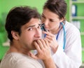 Female doctor checking patient`s ear during medical examination Royalty Free Stock Photo