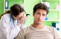 Female doctor checking patient`s ear during medical examination Royalty Free Stock Photo