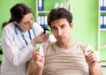 Female doctor checking patient`s ear during medical examination Royalty Free Stock Photo