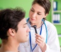 Female doctor checking patient`s ear during medical examination Royalty Free Stock Photo