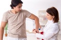 Female doctor checking patient`s joint flexibility with goniometer Royalty Free Stock Photo