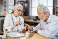 Female doctor checking pulse and saturation to senior man Royalty Free Stock Photo