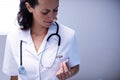 Female doctor checking time on pocket watch Royalty Free Stock Photo