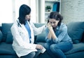 Woman patient receiving bad news. Friendly Doctor comforting and support sad patient with empathy Royalty Free Stock Photo