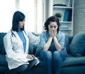 Woman patient receiving bad news. Friendly Doctor comforting and support sad patient with empathy Royalty Free Stock Photo