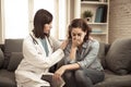 Woman patient receiving bad news. Friendly Doctor comforting and support sad patient with empathy Royalty Free Stock Photo