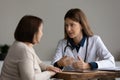 Female doctor consult mature patient at clinic Royalty Free Stock Photo