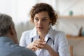 Female doctor consult mature patient in hospital Royalty Free Stock Photo