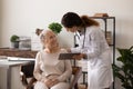 Female doctor consult senior patient using tablet Royalty Free Stock Photo