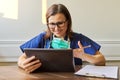 Female doctor counseling, helping patient online, medic using digital tablet for video call