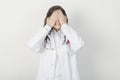 Female doctor covered her face with her hands. Royalty Free Stock Photo