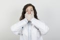 Female doctor covering her mouth with her hands. Royalty Free Stock Photo