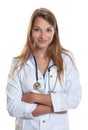 Female doctor with crossed arms smiling at camera Royalty Free Stock Photo