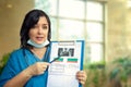 Female doctor demonstrates a bone density report.