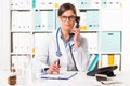 Female doctor at desk with telephone Royalty Free Stock Photo