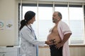 Female doctor examines patient and checkups for healthy diet. Royalty Free Stock Photo