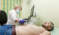 A female doctor examines a patient on an ultrasound machine Royalty Free Stock Photo