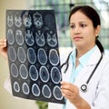 Female doctor examining a brain tomography scan Royalty Free Stock Photo