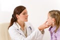 Female doctor examining child with sore throat Royalty Free Stock Photo