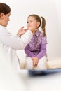 Female doctor examining child with sore throat Royalty Free Stock Photo