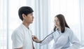 Female doctor examining the health of male patients chest with a stethoscope Royalty Free Stock Photo