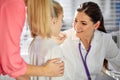 young female doctor examining little girl mouth at hospital office Royalty Free Stock Photo