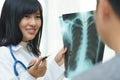 Female doctor examining about lungs with x-ray film - sick concept. Royalty Free Stock Photo