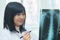 Female doctor examining about lungs with x-ray film - sick concept Royalty Free Stock Photo