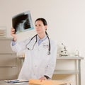 Female doctor examining patients x-rays Royalty Free Stock Photo