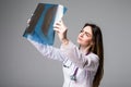 Female doctor examining an x-ray image. Focus is on the x-ray image on grey background. Royalty Free Stock Photo