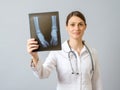 Female doctor examining x-ray image of legs of newborn baby