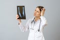 Female doctor examining x-ray image of legs of newborn baby