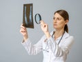 Female doctor examining x-ray image of legs of newborn baby Royalty Free Stock Photo