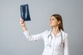 Female doctor examining x-ray image of legs of newborn baby Royalty Free Stock Photo