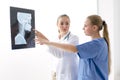 Female doctor explained the results of the X-ray examination.Female doctor examines the results of the X-ray.