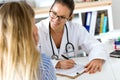 Female doctor explaining diagnosis to her patient. Royalty Free Stock Photo