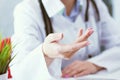 Female doctor explaining patient symptoms or asking a question as they discuss together in a consultation. Just hands Royalty Free Stock Photo