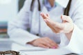 Female doctor explaining patient symptoms or asking a question as they discuss together in a consultation. Just hands Royalty Free Stock Photo