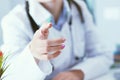 Female doctor explaining patient symptoms or asking a question as they discuss together in a consultation. Just hands Royalty Free Stock Photo