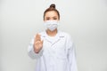 Female doctor in face mask showing stop sign with her hand Royalty Free Stock Photo