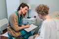 Female doctor filling out a questionnaire Royalty Free Stock Photo