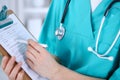 Female doctor filling up medical form on clipboard closeup. Physician finish up examining his patient in hospital an Royalty Free Stock Photo