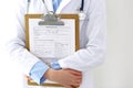 Female doctor filling up medical form on clipboard closeup. Physician finishing up examining his patient in hospital an Royalty Free Stock Photo