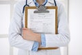 Female doctor filling up medical form on clipboard closeup. Physician finishing up examining his patient in hospital an Royalty Free Stock Photo