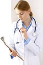 Female doctor filling up medical form on clipboard closeup. Physician finishing up examining his patient in hospital an Royalty Free Stock Photo