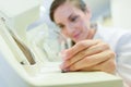 Female doctor fixes glasses in laboratory