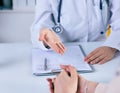 Female doctor giving a consultation to a patient and explaining medical informations and diagnosis. Just hands over the Royalty Free Stock Photo