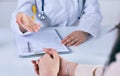 Female doctor giving a consultation to a patient and explaining medical informations and diagnosis. Just hands over the Royalty Free Stock Photo