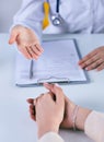 Female doctor giving a consultation to a patient and explaining medical informations and diagnosis. Just hands over the Royalty Free Stock Photo